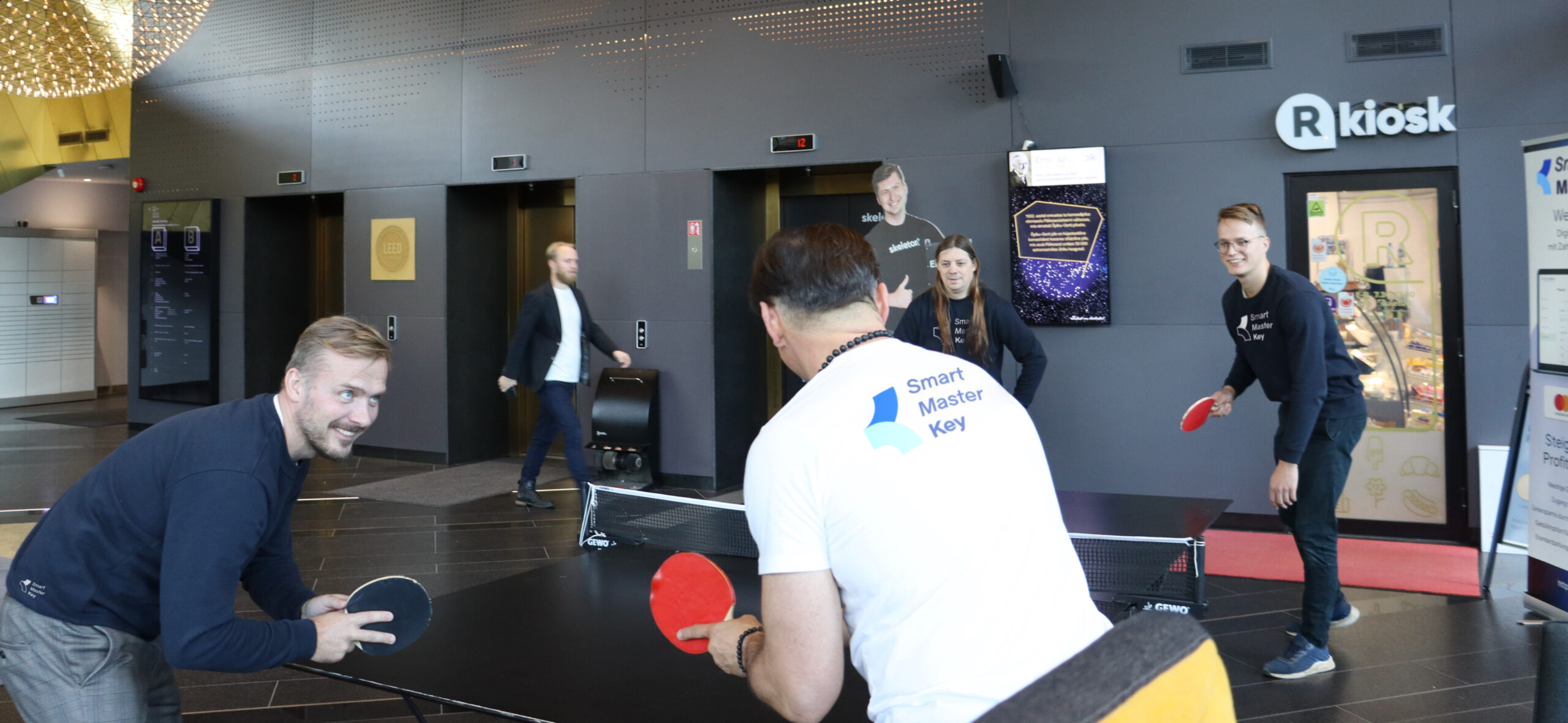 Smart MasterKey team members playing table tennis